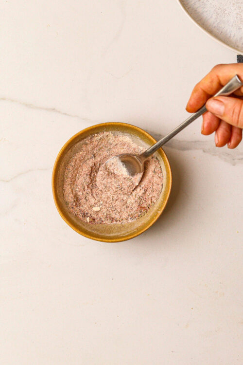 Finely ground pink Himalayan salt in a small bowl, ready for cooking or seasoning.