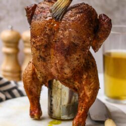 Crispy roasted whole chicken with basting brush.