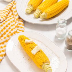 Golden grilled corn on the cob with butter, perfect for summer recipes and outdoor dining.