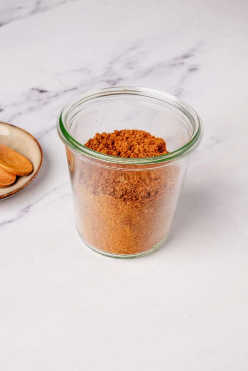 Ground cinnamon in a glass jar for baking and cooking.