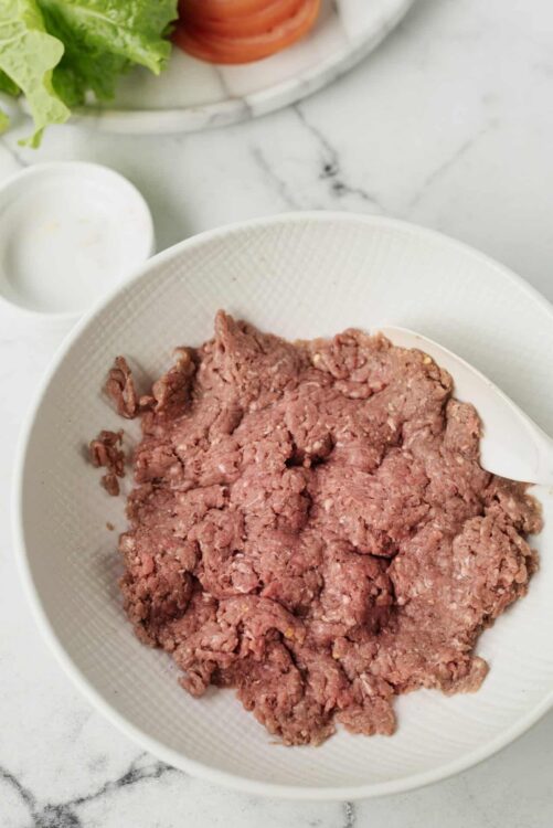Fresh ground beef in a white bowl, used for baking recipes and cooking.