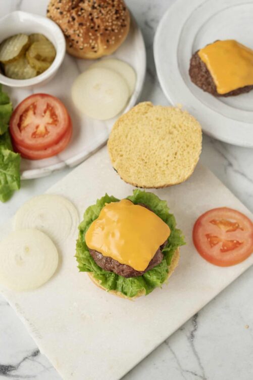 Juicy cheeseburger with melted cheddar, fresh lettuce on a toasted bun.