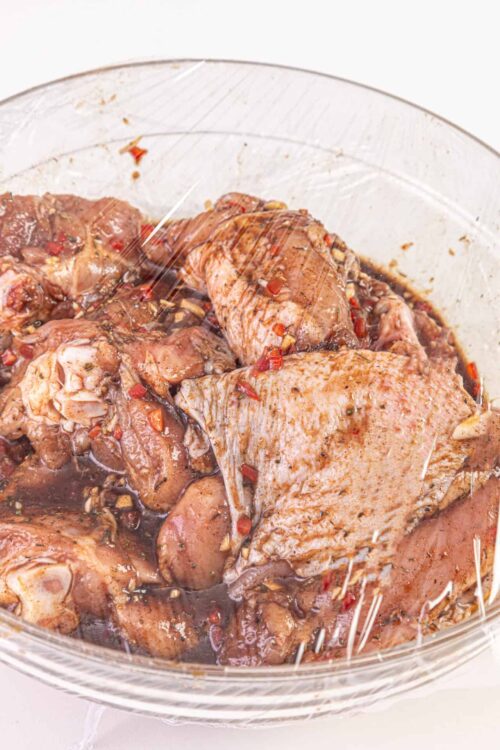 Slow cooked marinated chicken thighs in a savory sauce.