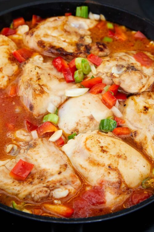 Savory chicken thighs cooked in tomato sauce with vegetables and melted cheese.