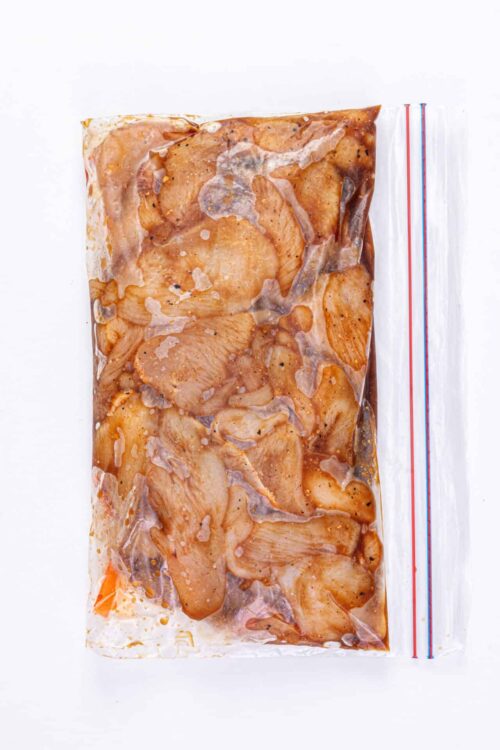 Marinated chicken in vacuum-sealed bag for baking or grilling.