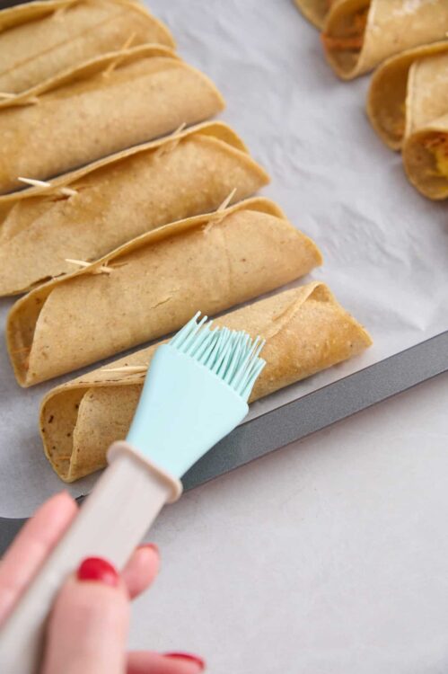 Golden baked beef tacos with crispy shells on baking sheet, ready for filling or serving, homemade Tex-Mex recipe.