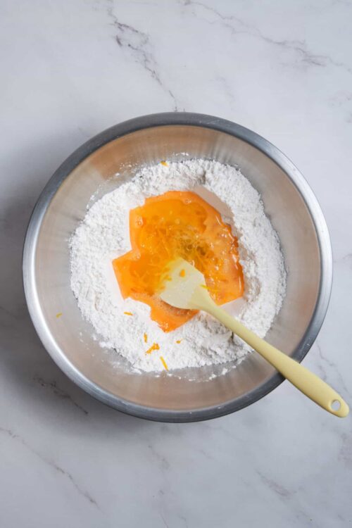Flour and egg in mixing bowl for baking cookies or cake.