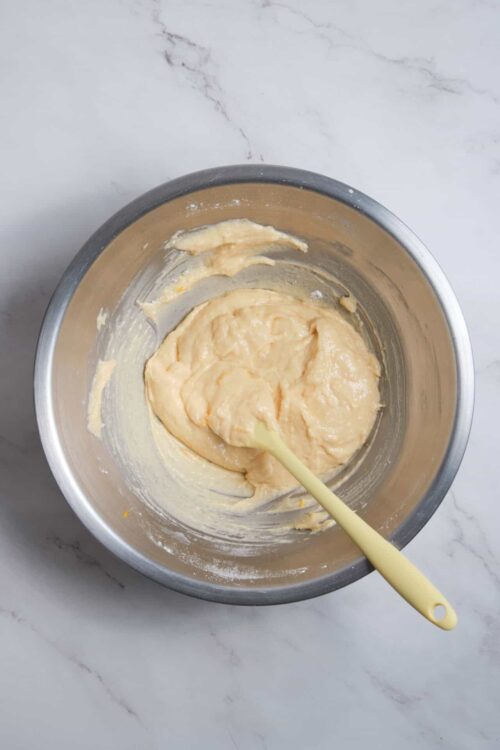 Fluffy, creamy batter in a metal mixing bowl for baking recipes.