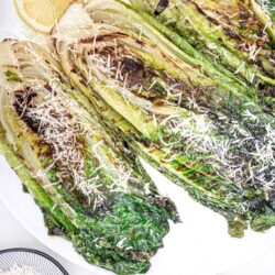 Roasted Romaine lettuce with Parmesan cheese and lemon slices, salad garnish, easy side dish recipe.