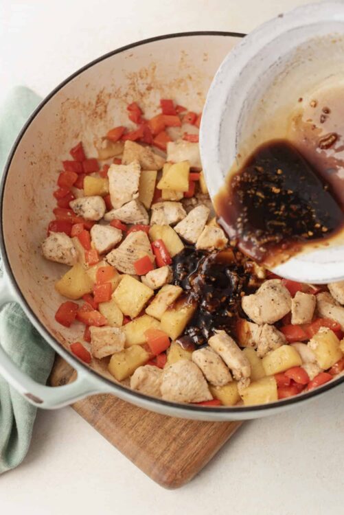 Savory chicken and vegetable stir-fry with soy sauce in a Dutch oven.