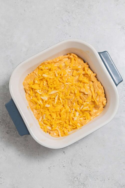 Cheesy baked casserole in a white baking dish.