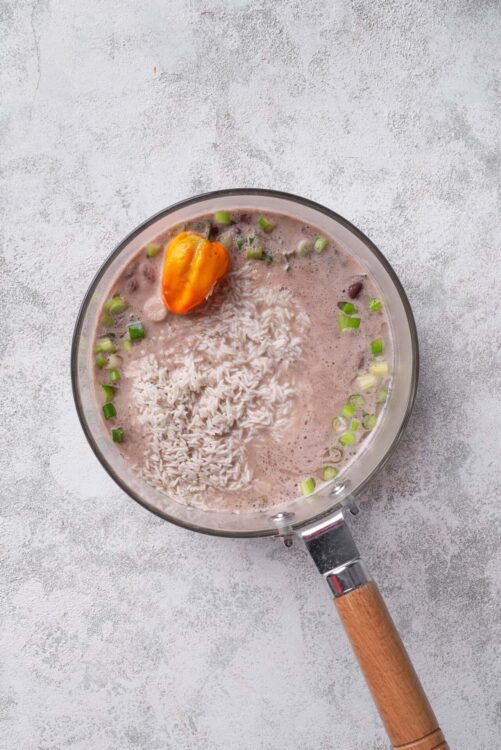 Creamy coconut rice pudding with fresh green onions and a spicy habanero pepper. Perfect for cozy dessert or comforting snack.