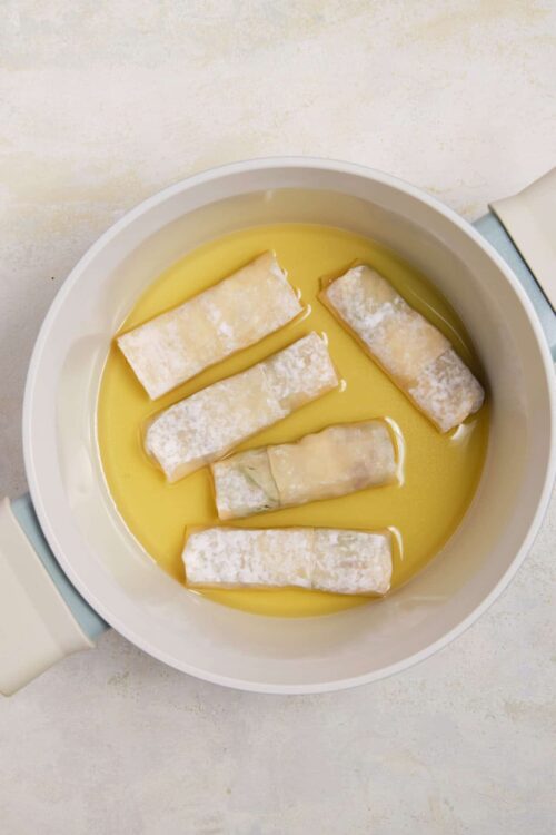 Soft cheese and butter melting in a saucepan, ready for making cheese-filled pastry or casserole.