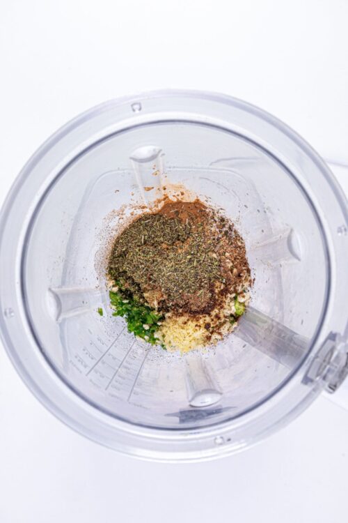 Ground herbs and spices in a food processor for cooking or seasoning.
