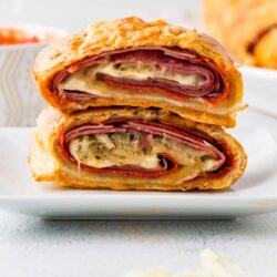 Thinly sliced ham, cheese, and herbs wrapped in flaky pastry, baked until golden brown for classic ham Wellington.