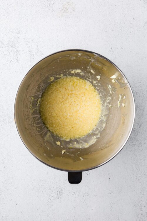 Creamy melted butter and sugar mixture in a stand mixer bowl, ready for baking.