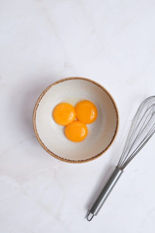 Juice eggs in a ceramic bowl for baking recipes.