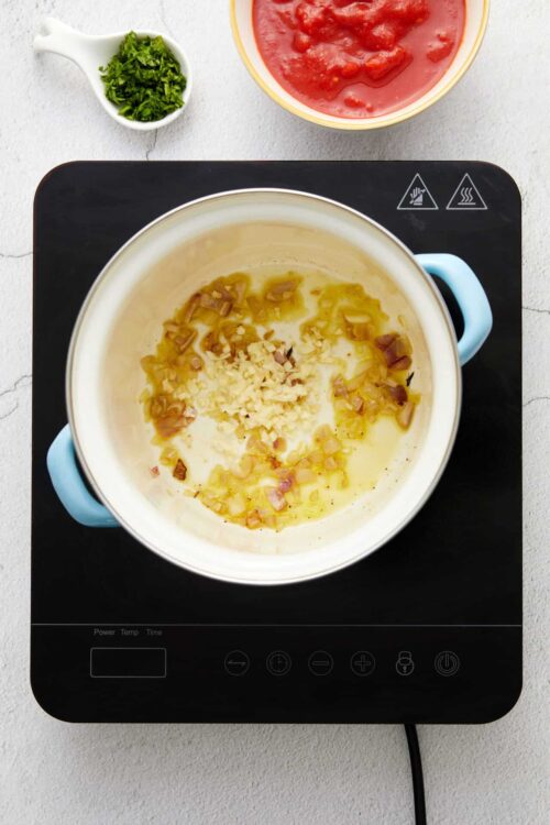 Minced garlic and chopped shallots in a creamy white sauce.