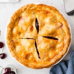 Sweet cherry pie with golden flaky crust and fresh cherries, delicious dessert recipe.