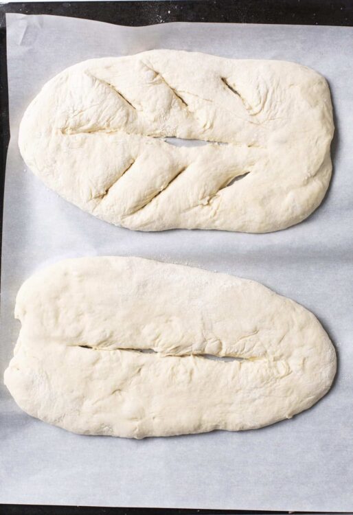Flaky homemade bread dough ready for baking, relaxed and soft texture.