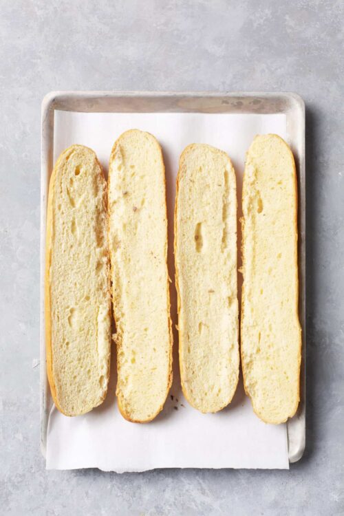 Fluffy baked cheese bread sliced and ready to serve, fresh from the oven.