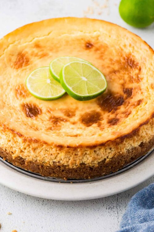 Lemon bar with fresh lime slices on top, creamy filling and golden crust.