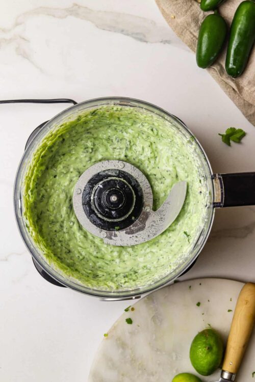 Creamy cucumber salsa in a food processor with fresh limes and jalapeños. Perfect for summer appetizers and dips.