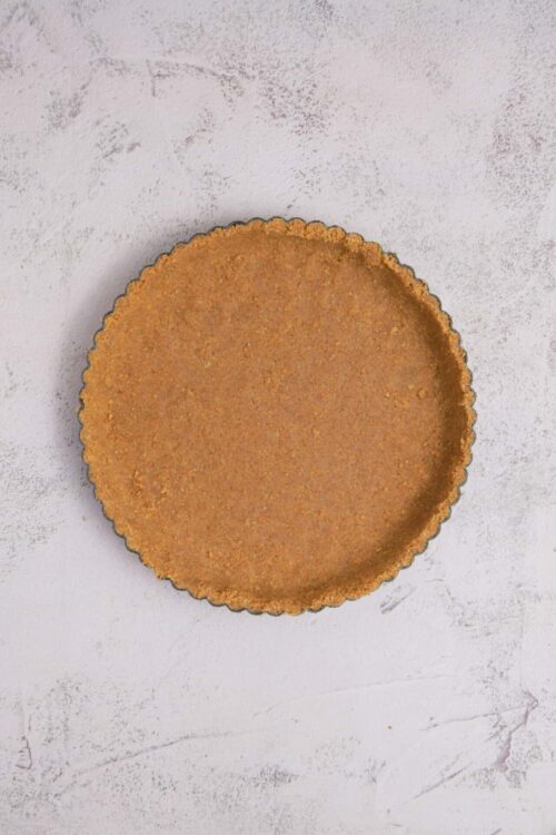 Graham cracker crust on a white textured background.