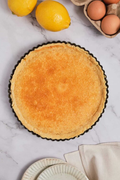 Creamy lemon dessert tart with a golden crust, perfect for spring desserts.