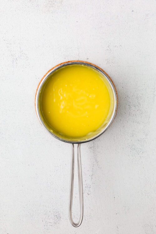 Creamy melted butter in a small saucepan for baking or cooking.