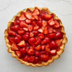 Fresh strawberry tart with glazed berries and a flaky crust, perfect for summer desserts.