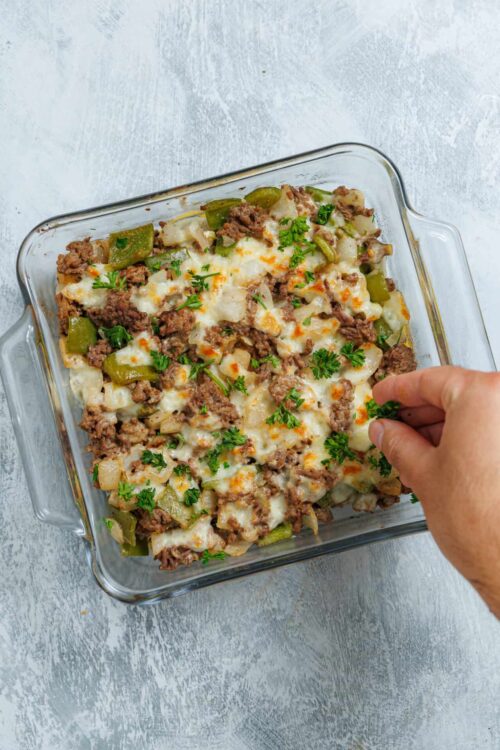 Savory ground beef and potato casserole in glass baking dish.
