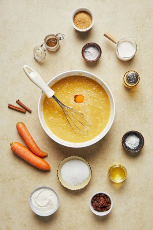 Buttermilk Carrot Cake Batter with Spices and Ingredients on a Light Surface.