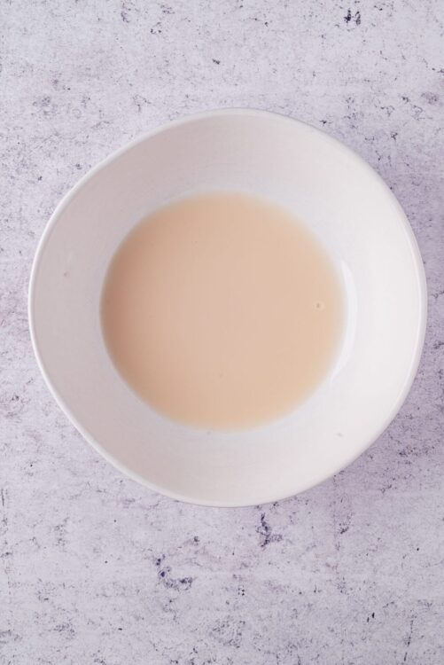 Creamy milk in a white bowl for baking or cooking.