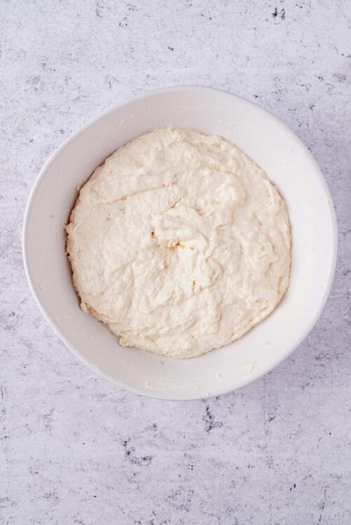 Creamy unbaked dough mixture for homemade baked goods in a white bowl.