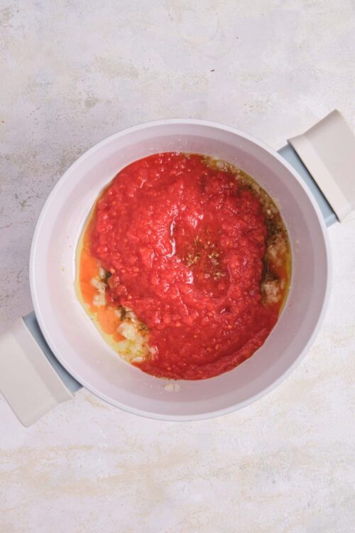 Cooked tomato sauce in a slow cooker over mashed potatoes.