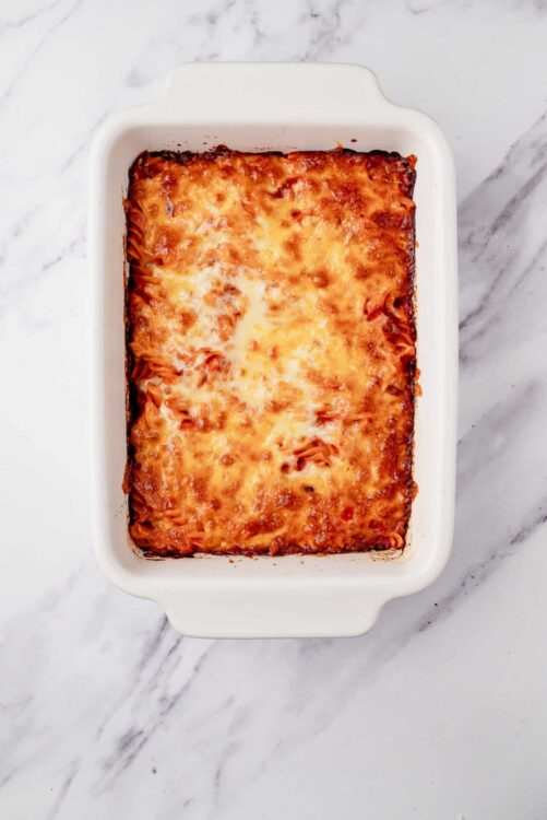 Baked cheese lasagna in a white baking dish, homemade Italian casserole.
