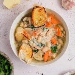 Creamy bean and vegetable soup with toasted bread croutons, garlic, and cheese; baked and served warm.