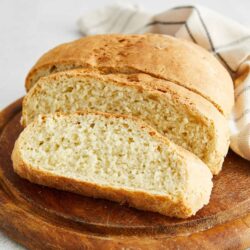Fluffy homemade bread on a wooden cutting board.
