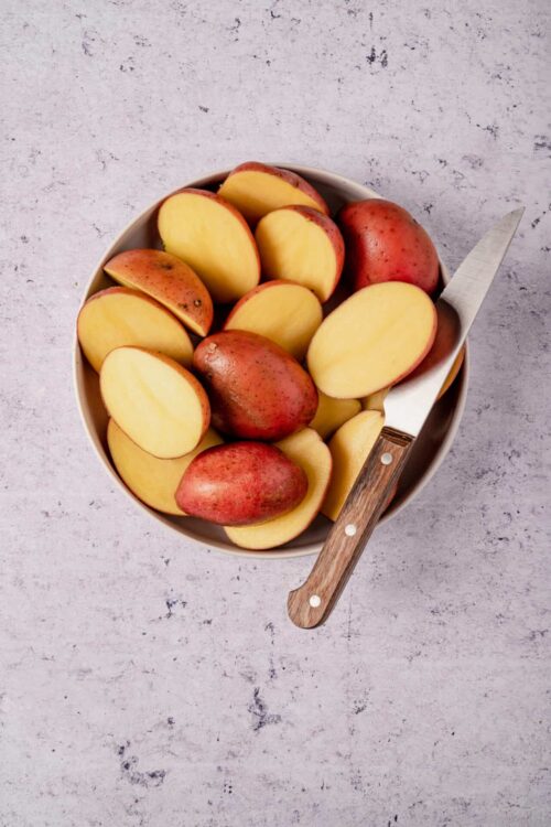Fresh red and yellow potatoes in a bowl for baking or cooking.
