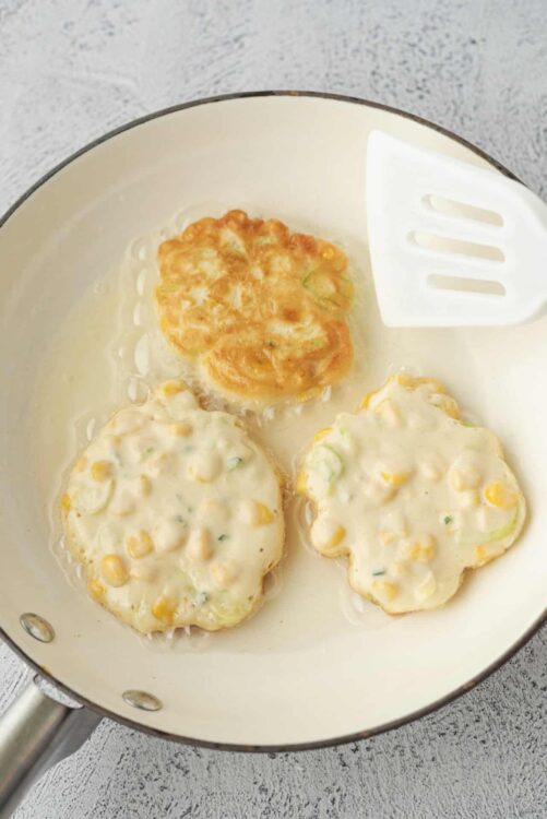 Sausage and vegetable breakfast patties in a non-stick skillet.