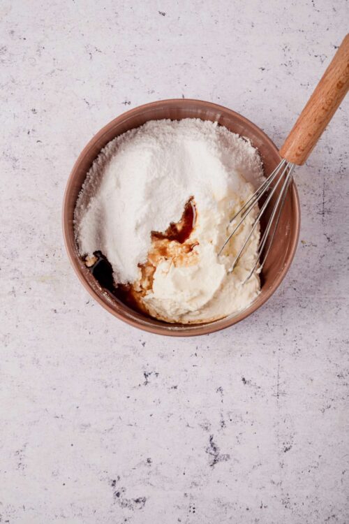 Butter and sugar mixture with vanilla extract in a mixing bowl, ready to be baked.