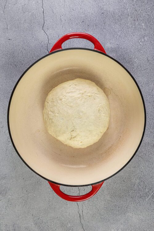 Fermentation dough in a Dutch oven for baking bread, fresh homemade bread preparation.