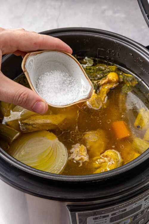 Seasoned chicken and vegetables cooking in an instant pot for a comforting homemade soup.