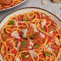 Spaghetti and meatballs with tomato sauce and Parmesan cheese.