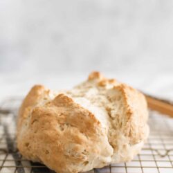 Fresh homemade bread with a rustic crust on a wire rack.