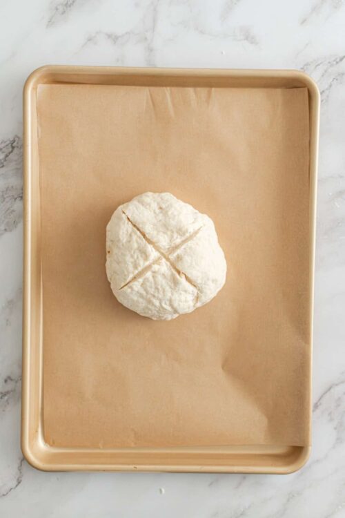 Soft cheese ball on a baking sheet before baking, ready for cheese making or baking recipes.