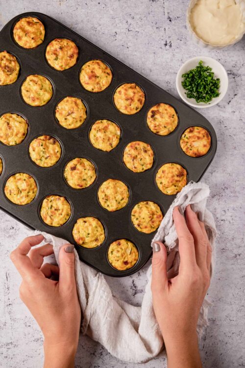 Mini breakfast egg muffins cooked in a muffin tin, fresh from the oven.