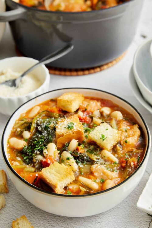 Creamy vegetable and white bean soup topped with croutons and Parmesan cheese. Perfect for cozy meals and healthy comfort food.