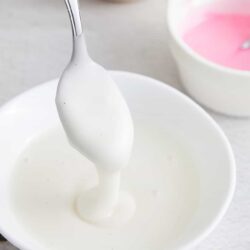 Fluffy whipped cream in white bowl, perfect for desserts or baking.